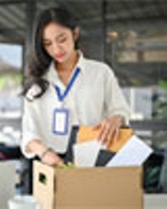 Woman, laid off, packing her desk